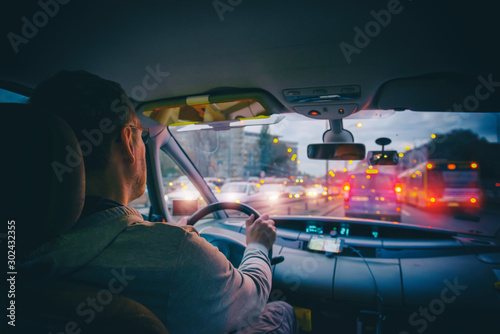 Bild auf Leinwand Driving a car in the city at night in traffic jams