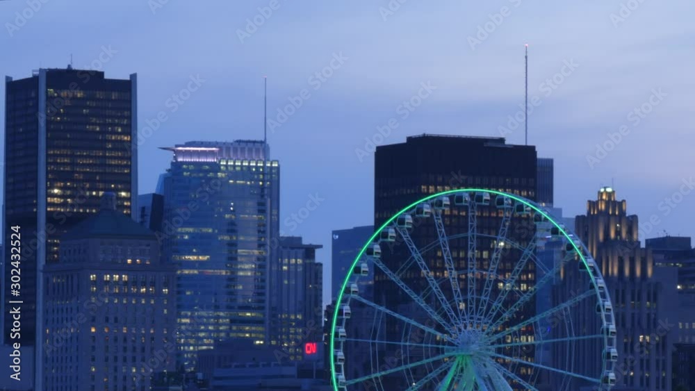 Time lapse, Ferris wheel rotating, Montreal downtown, old port view, buildings, skyscrapers and beautiful sunset time view, day to night timelapse. Time lapse, Ferris wheel rotating, Montreal downtown, old port view, buildings, skyscrapers and beautiful sunset time view, day to night timelapse.