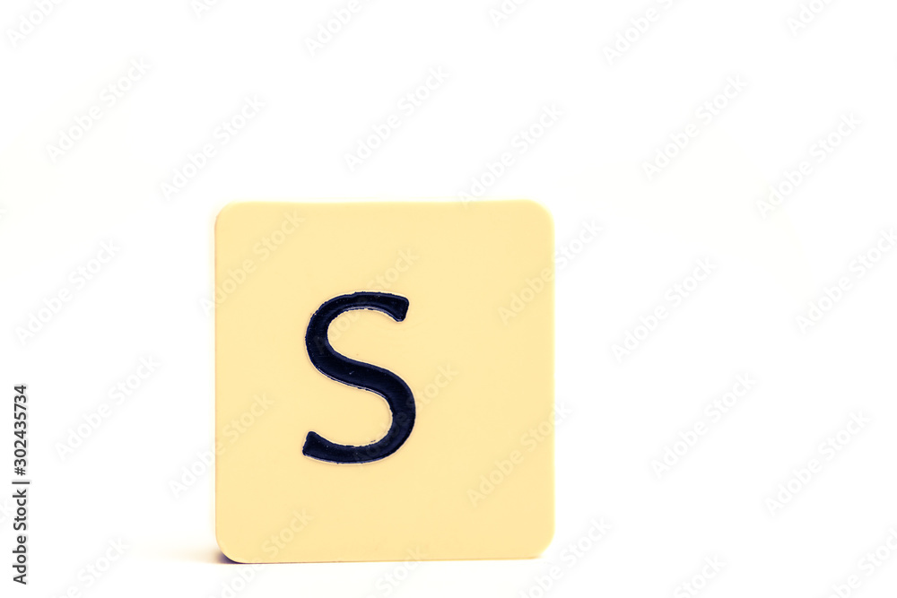 Dark letter S on a pale yellow square block isolated on white background Dark letter S on a pale yellow square block isolated on white background