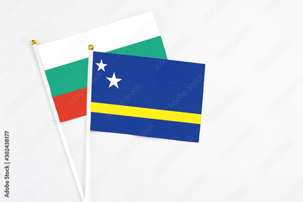Curacao and Bulgaria stick flags on white background. High quality fabric, miniature national flag. Peaceful global concept.White floor for copy space. Curacao and Bulgaria stick flags on white background. High quality fabric, miniature national flag. Peaceful global concept.White floor for copy space.