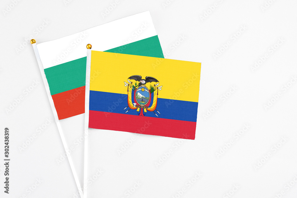 Naklejka premium Ecuador and Bulgaria stick flags on white background. High quality fabric, miniature national flag. Peaceful global concept.White floor for copy space.