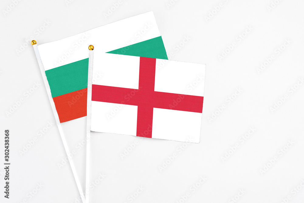 England and Bulgaria stick flags on white background. High quality fabric, miniature national flag. Peaceful global concept.White floor for copy space.