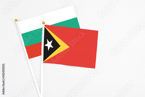 Free Download East Timor and Bulgaria stick flags on white background. High quality fabric, miniature national flag. Peaceful global concept.White floor for copy space. - GFXLoad