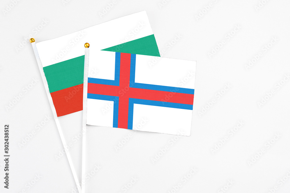 Faroe Islands and Bulgaria stick flags on white background. High quality fabric, miniature national flag. Peaceful global concept.White floor for copy space.