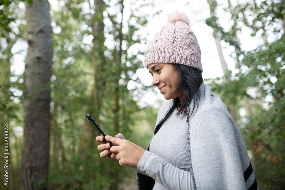 woman using mobile in nature woman using mobile in nature