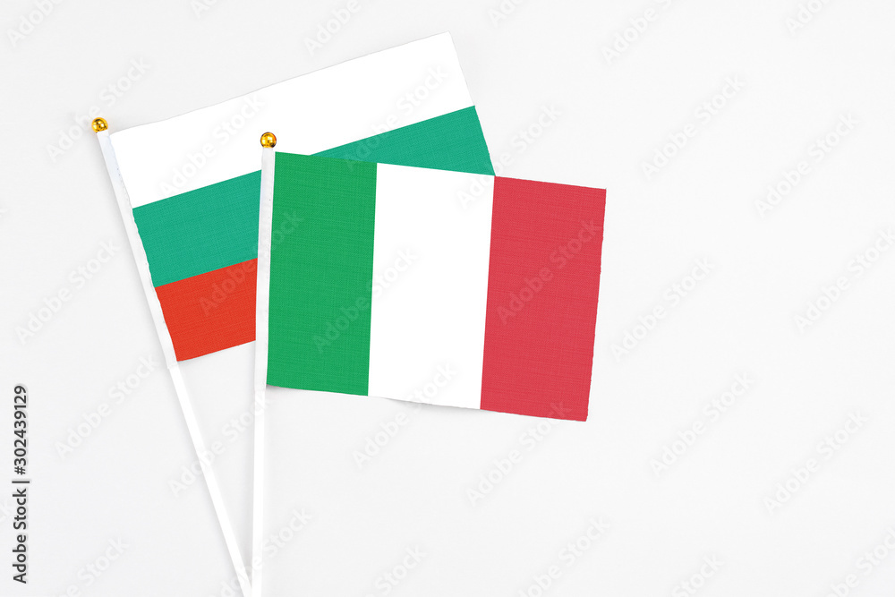 Italy and Bulgaria stick flags on white background. High quality fabric, miniature national flag. Peaceful global concept.White floor for copy space.