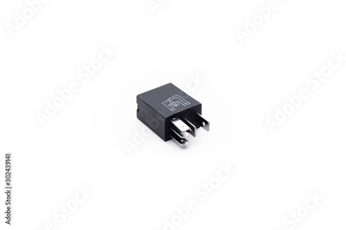 Car electric relay switch on isolated white background. Car electric spare part.