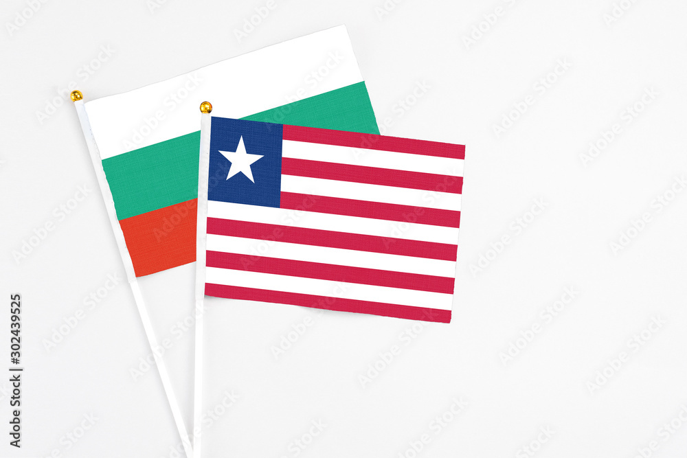 Liberia and Bulgaria stick flags on white background. High quality fabric, miniature national flag. Peaceful global concept.White floor for copy space. Liberia and Bulgaria stick flags on white background. High quality fabric, miniature national flag. Peaceful global concept.White floor for copy space.