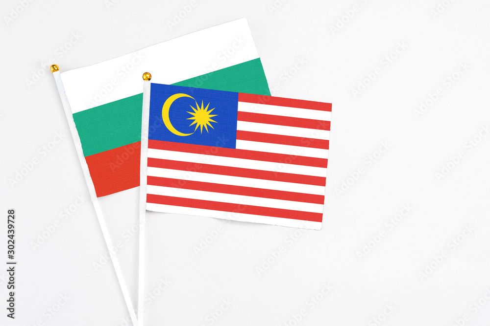 Malaysia and Bulgaria stick flags on white background. High quality fabric, miniature national flag. Peaceful global concept.White floor for copy space. Malaysia and Bulgaria stick flags on white background. High quality fabric, miniature national flag. Peaceful global concept.White floor for copy space.