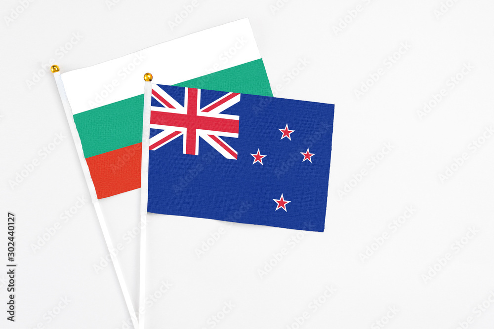 New Zealand and Bulgaria stick flags on white background. High quality fabric, miniature national flag. Peaceful global concept.White floor for copy space. New Zealand and Bulgaria stick flags on white background. High quality fabric, miniature national flag. Peaceful global concept.White floor for copy space.