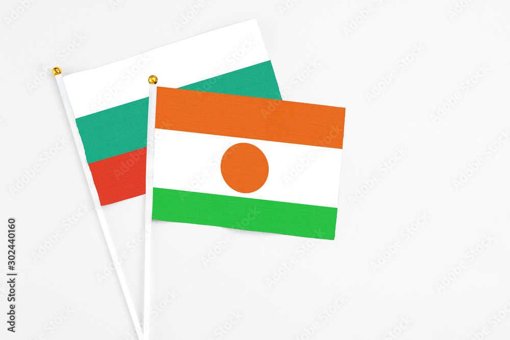 Niger and Bulgaria stick flags on white background. High quality fabric, miniature national flag. Peaceful global concept.White floor for copy space.