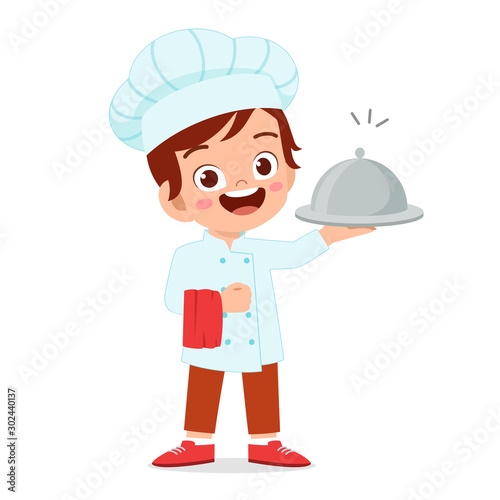 happy cute kid boy in chef costume