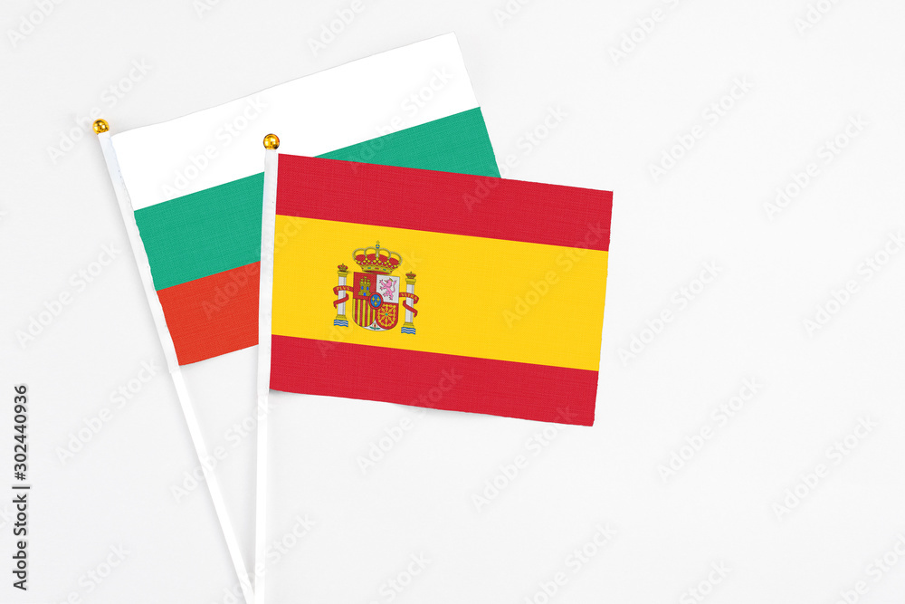 Spain and Bulgaria stick flags on white background. High quality fabric, miniature national flag. Peaceful global concept.White floor for copy space. Spain and Bulgaria stick flags on white background. High quality fabric, miniature national flag. Peaceful global concept.White floor for copy space.