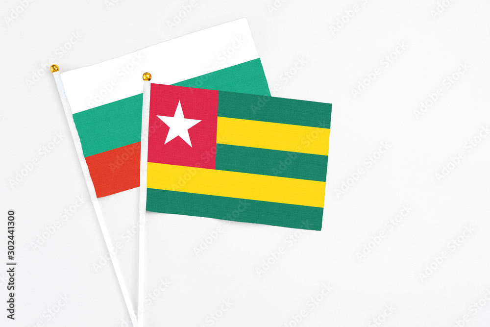 Togo and Bulgaria stick flags on white background. High quality fabric, miniature national flag. Peaceful global concept.White floor for copy space. Togo and Bulgaria stick flags on white background. High quality fabric, miniature national flag. Peaceful global concept.White floor for copy space.