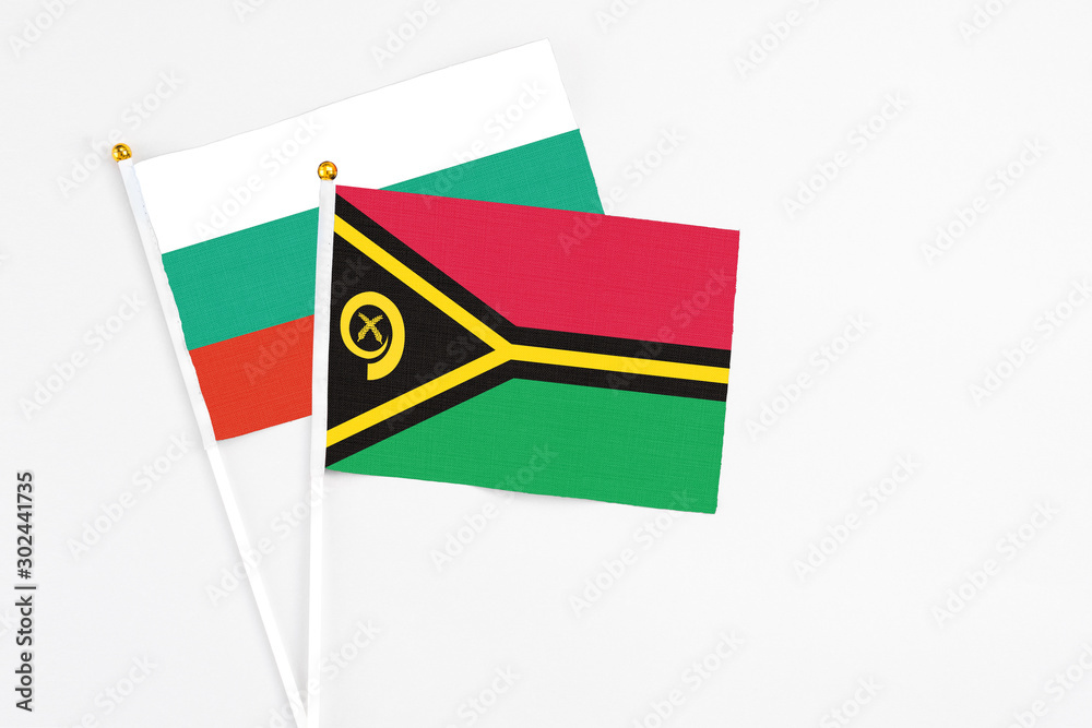 Fototapeta premium Vanuatu and Bulgaria stick flags on white background. High quality fabric, miniature national flag. Peaceful global concept.White floor for copy space.