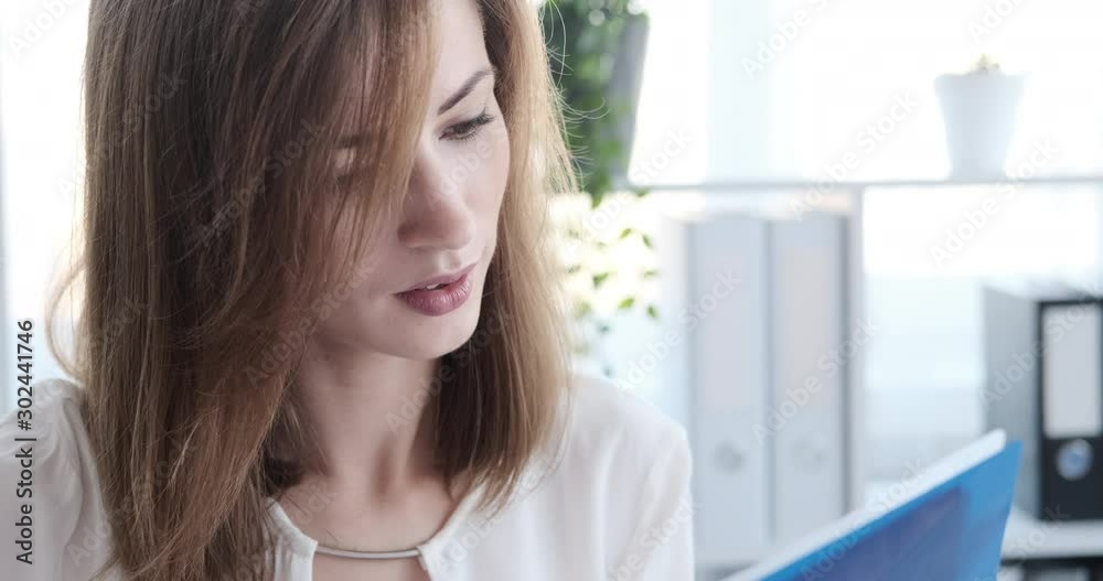 Smiling businesswoman busy working on laptop at office Smiling businesswoman busy working on laptop at office