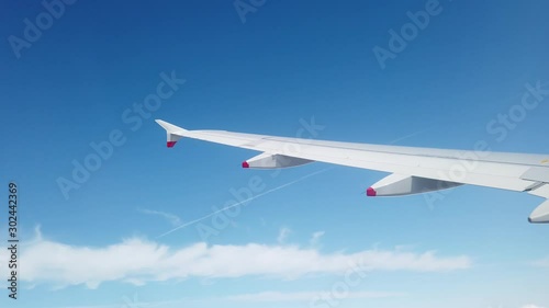 San Francisco, USA - August 2019: Wing of an airplane turning before landing