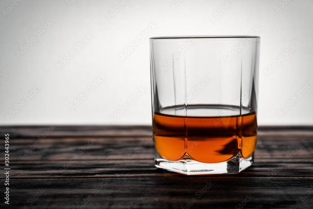 glass of whiskey on a wooden table in a bar glass of whiskey on a wooden table in a bar