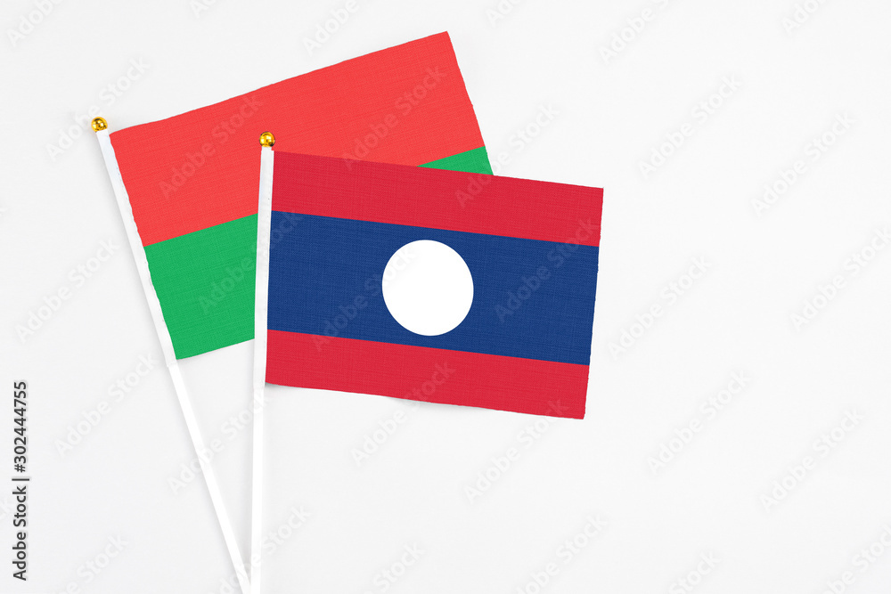 Laos and Burkina Faso stick flags on white background. High quality fabric, miniature national flag. Peaceful global concept.White floor for copy space. Laos and Burkina Faso stick flags on white background. High quality fabric, miniature national flag. Peaceful global concept.White floor for copy space.