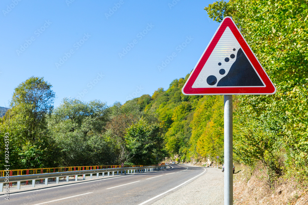 warning road sign - rockfall possible warning road sign - rockfall possible
