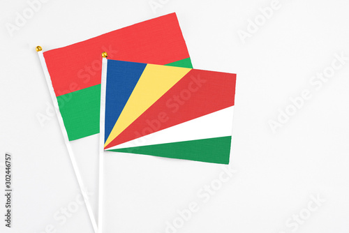Free Download Seychelles and Burkina Faso stick flags on white background. High quality fabric, miniature national flag. Peaceful global concept.White floor for copy space. - GFXLoad