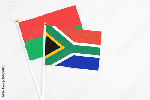 Free Download South Africa and Burkina Faso stick flags on white background. High quality fabric, miniature national flag. Peaceful global concept.White floor for copy space. - GFXLoad