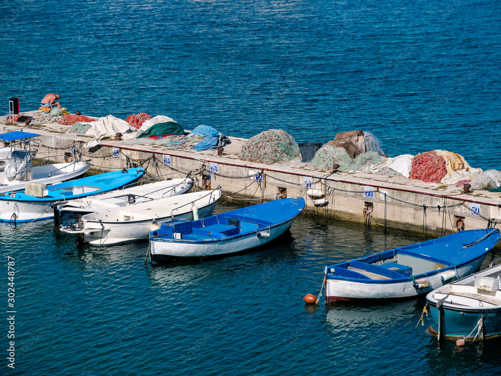Boats in the mediterranean harbor at the travel destination Gallipoli in Puglia on a deep blue ocean