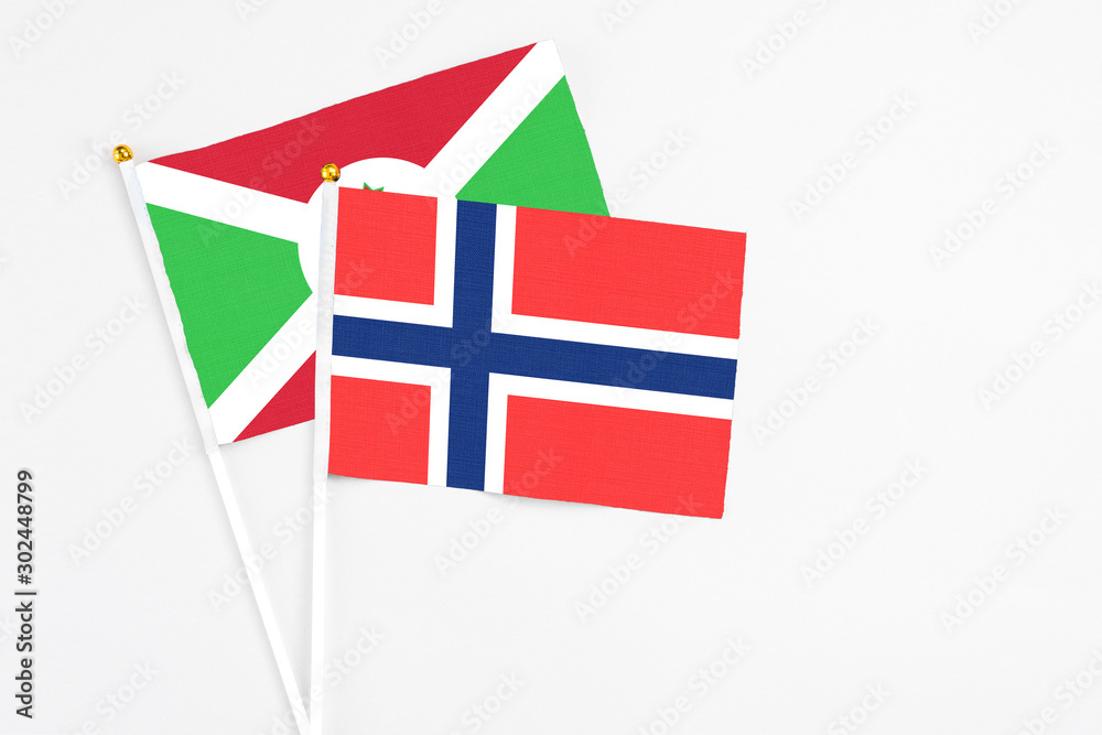 Bouvet Islands and Burundi stick flags on white background. High quality fabric, miniature national flag. Peaceful global concept.White floor for copy space.