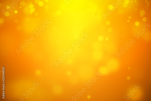 Bokeh abstract blurred orange and yellow beautiful background. Soft color light glitter sparkles. element for backdrop or design cosmetic ads, happy new year, halloween, beauty, summer, christmas