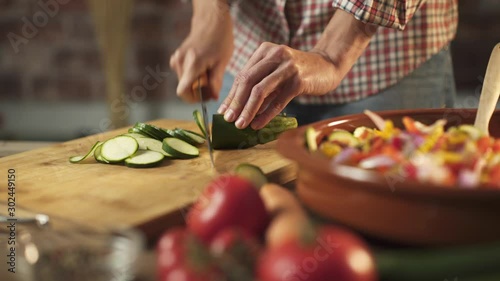 Woman slicing fresh healthy vegetables in the kitchen