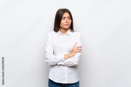 Young woman over isolated white background thinking an idea