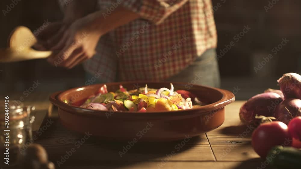 Woman mixing sliced vegetables in a bowl