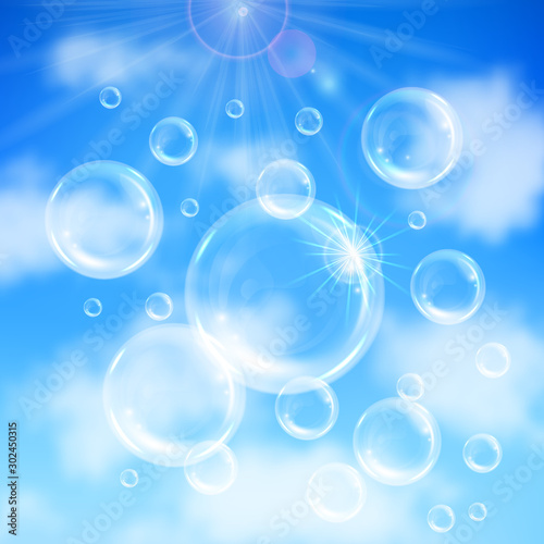 Realistic transparent floating soap bubbles on blue sky background. Design element for advertising booklet  flyer or poster