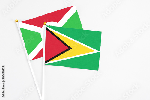 Free Download Guyana and Burundi stick flags on white background. High quality fabric, miniature national flag. Peaceful global concept.White floor for copy space. - GFXLoad