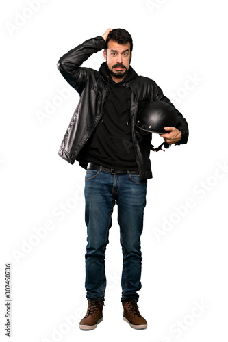 Full-length shot of Biker man frustrated and takes hands on head over isolated white background