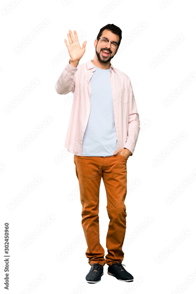 Full-length shot of Handsome man with beard saluting with hand with happy expression over isolated white background Full-length shot of Handsome man with beard saluting with hand with happy expression over isolated white background