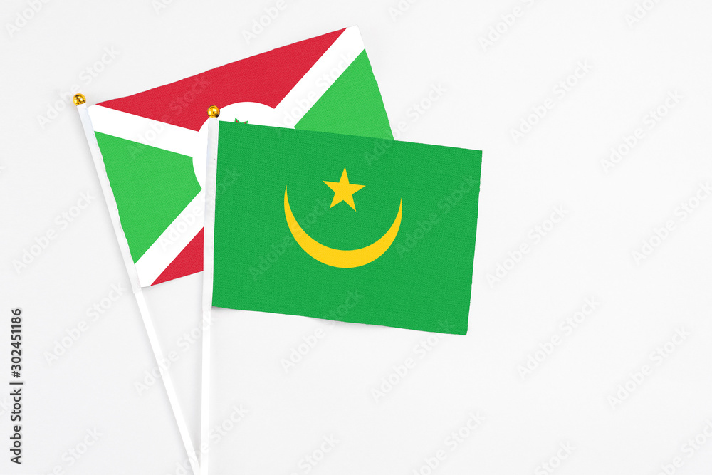 Mauritania and Burundi stick flags on white background. High quality fabric, miniature national flag. Peaceful global concept.White floor for copy space. Mauritania and Burundi stick flags on white background. High quality fabric, miniature national flag. Peaceful global concept.White floor for copy space.