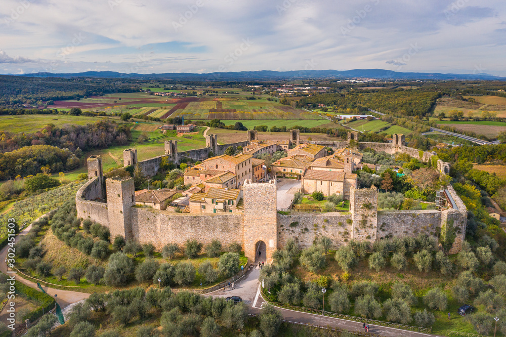 aerial view to facade of medieval castle Monteriggioni in Tuscany in Italy from drone