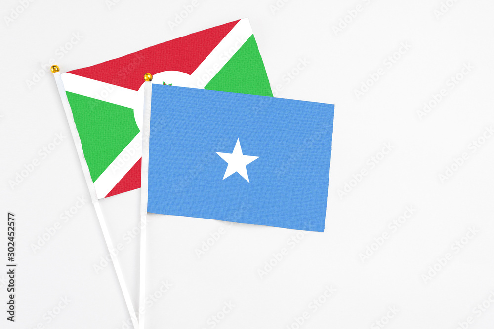 Somalia and Burundi stick flags on white background. High quality fabric, miniature national flag. Peaceful global concept.White floor for copy space. Somalia and Burundi stick flags on white background. High quality fabric, miniature national flag. Peaceful global concept.White floor for copy space.