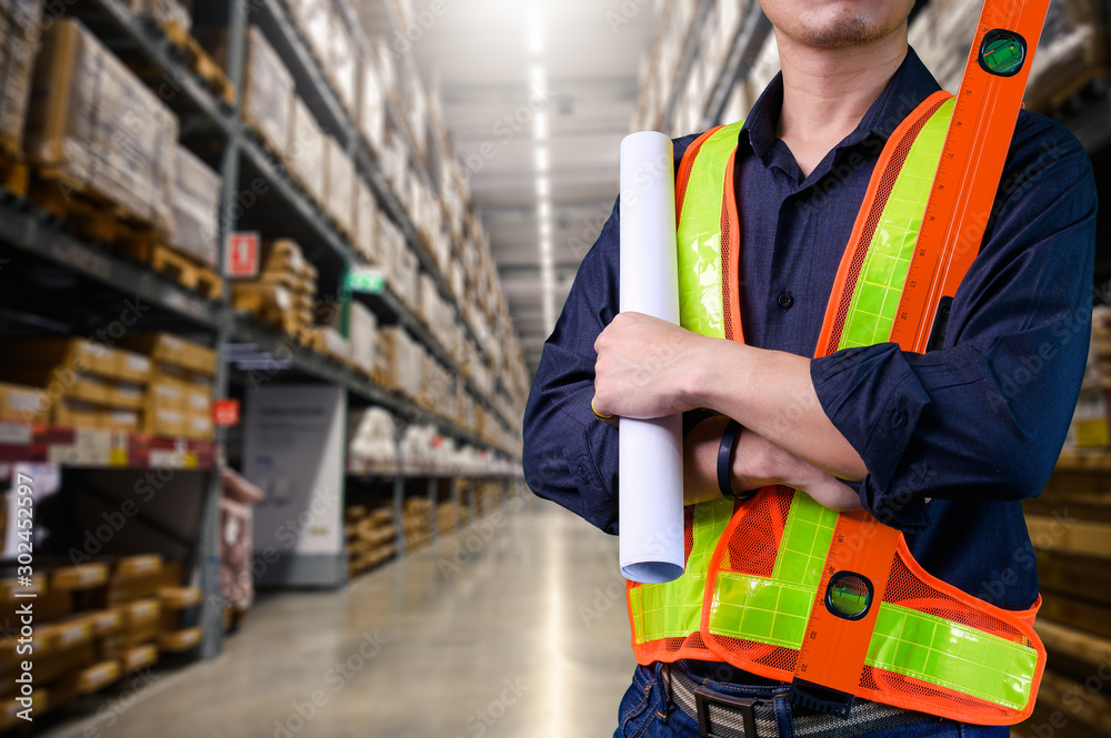 The abstract image of the engineer standing in front of the warehouse storage. the concept of engineering, shipping, management, warehouse and transportations. The abstract image of the engineer standing in front of the warehouse storage. the concept of engineering, shipping, management, warehouse and transportations.