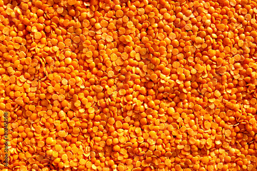 Red lentils background. Top view. Food background. Lentil grains texture