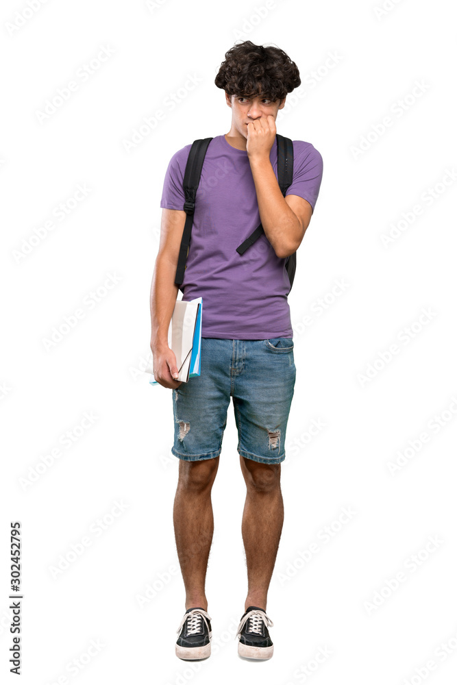 A full-length shot of a Young student man nervous and scared putting hands to mouth over isolated white background A full-length shot of a Young student man nervous and scared putting hands to mouth over isolated white background