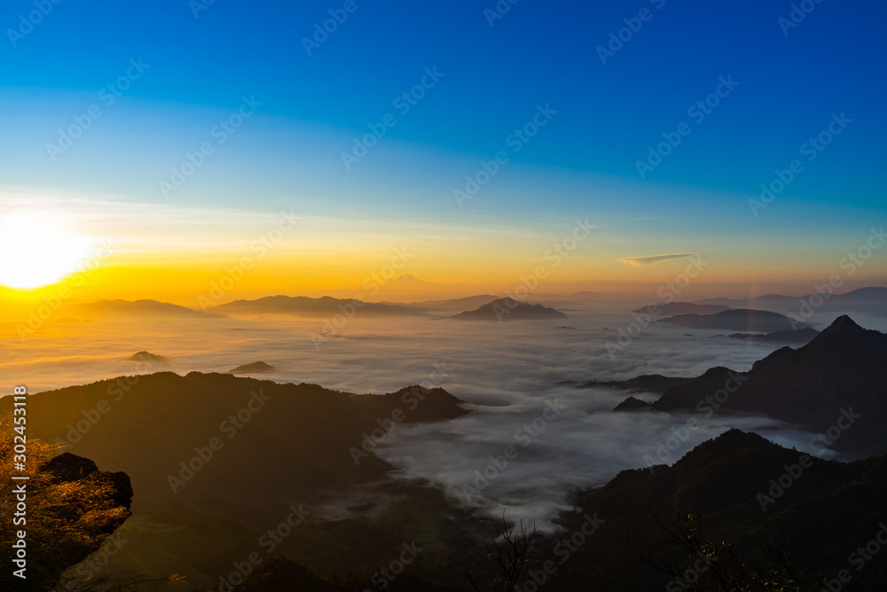 Fototapeta premium Sunrise and Mist mountain in Phu Chi Fa located in Chiang Rai, Thailand. Phu Chi Fa is the natural border between Thailand and Laos.
