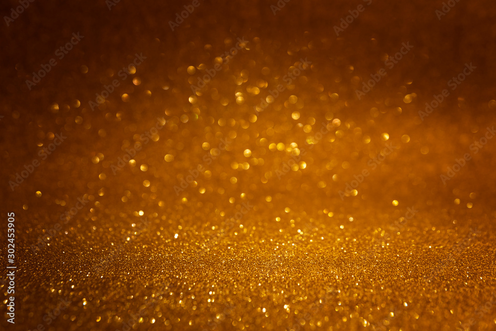 Golden abstract glittering background. Defocused lights. Christmas greeting card. Christmas or New Year celebration concept. Copy space. Soft focus Golden abstract glittering background. Defocused lights. Christmas greeting card. Christmas or New Year celebration concept. Copy space. Soft focus
