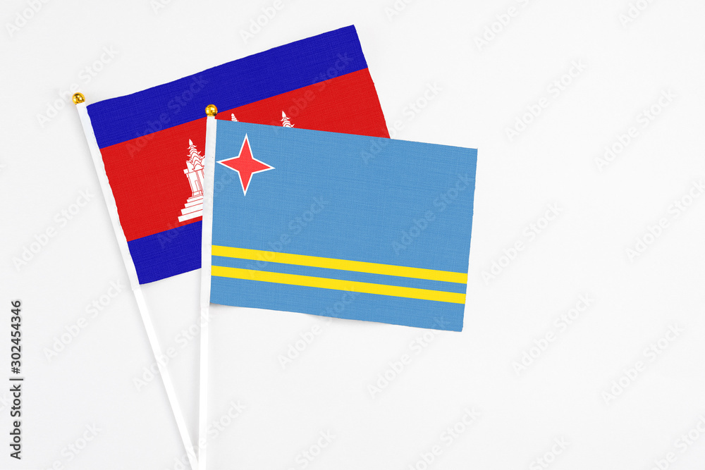 Aruba and Cambodia stick flags on white background. High quality fabric, miniature national flag. Peaceful global concept.White floor for copy space. Aruba and Cambodia stick flags on white background. High quality fabric, miniature national flag. Peaceful global concept.White floor for copy space.
