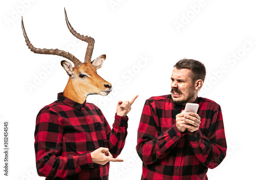 Photography Portrait of man arguing with himself as a deer on white studio background
