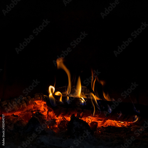 Wood burning in the fireplace. Close up.