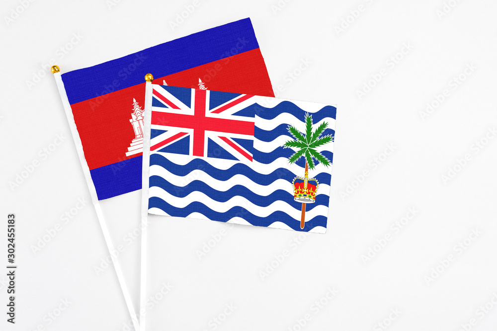Fototapeta premium British Indian Ocean Territory and Cambodia stick flags on white background. High quality fabric, miniature national flag. Peaceful global concept.White floor for copy space.