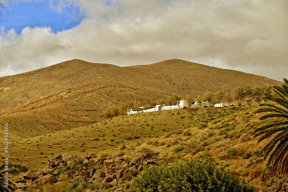  empty mysterious mountainous landscape from the center of the Canary Island Spanish Fuerteventura with a cloudy sky