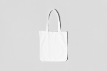 White tote bag mockup on a grey background.